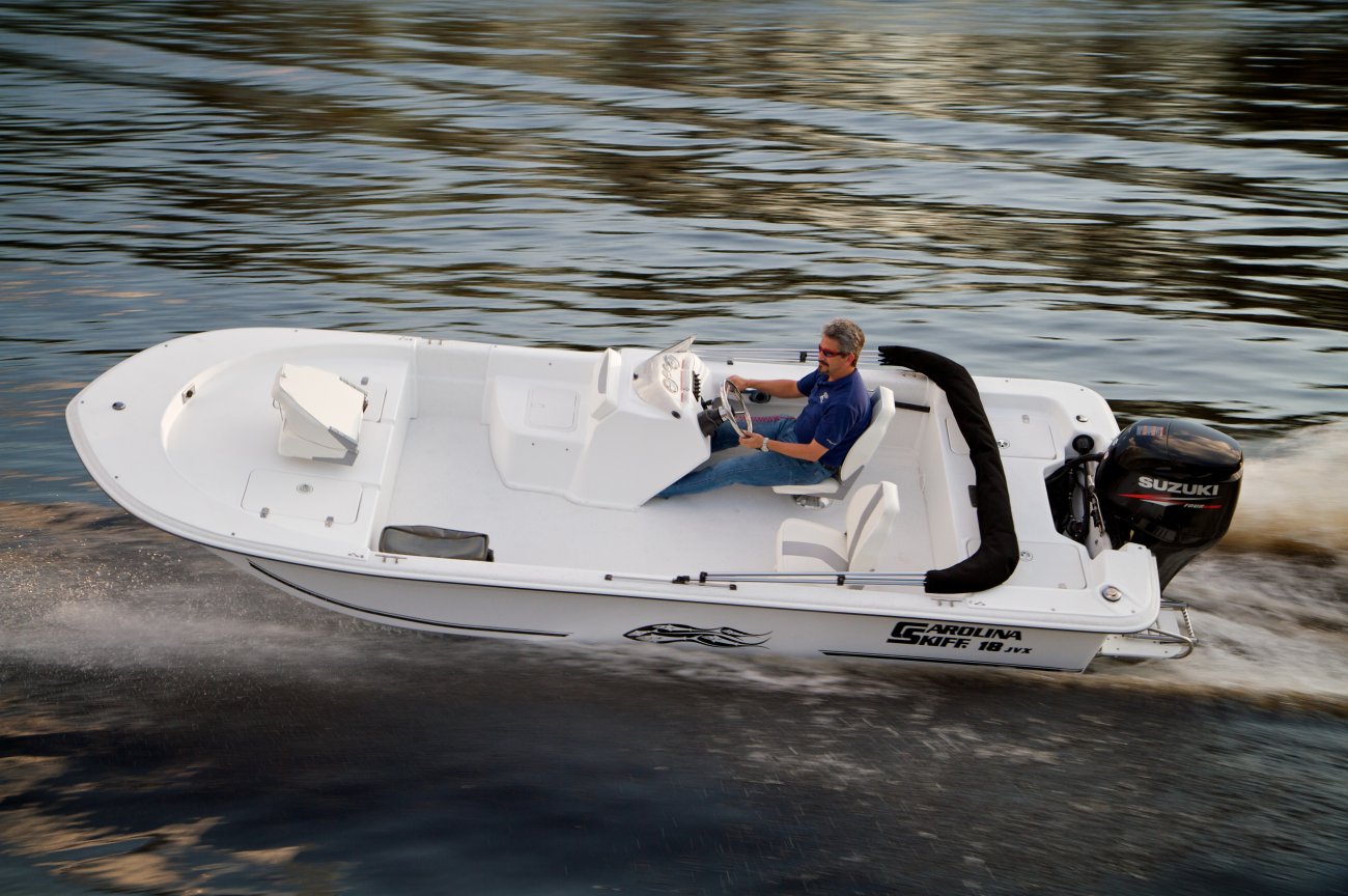 The definition of an outboard motor is a detachable engine mounted on outboard brackets on the stern of your boat.  This configuration will have only one single engine.